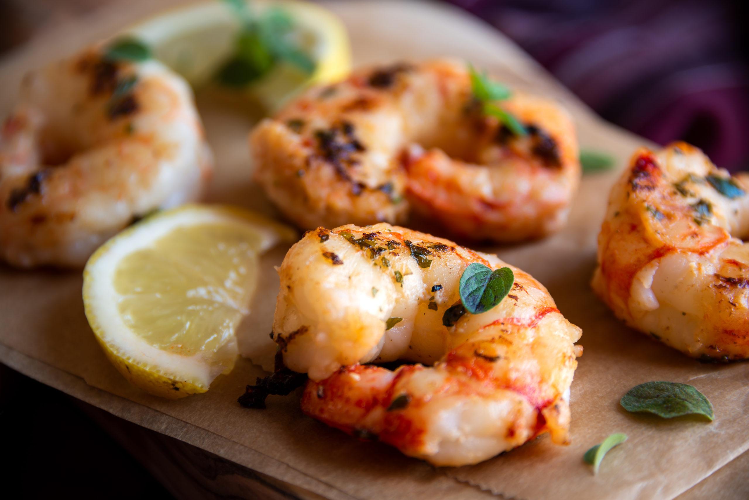 Roasted shrimps with lemon and herbs, healthy seafood snack